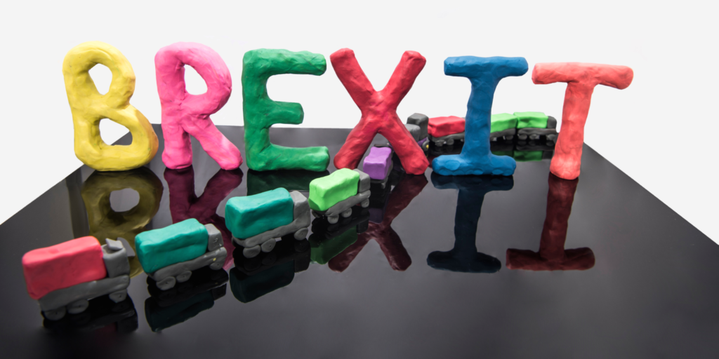 Abstract image of the word BREXIT and a line of trucks made out of Plasticine.