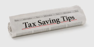 Rolled up newspaper with the heading Tax Saving Tips.