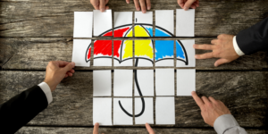 Overhead shot with cards lying on a wooden desk arranged to create an image of an umbrella.