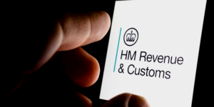 Mobile telephone screen displaying the HM Revenue & Customs' with government crown logo.