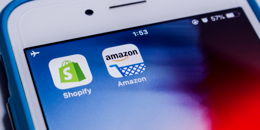 Mobile phone screen with Shopify and Amazon App icons displayed.