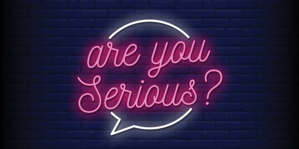 Pink neon sign with black brick background - 'are you Serious?'