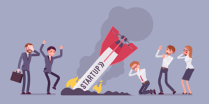 Illustration of business people in distressed mode looking at a crash landed rocket with 'STARTUP' displayed on it.