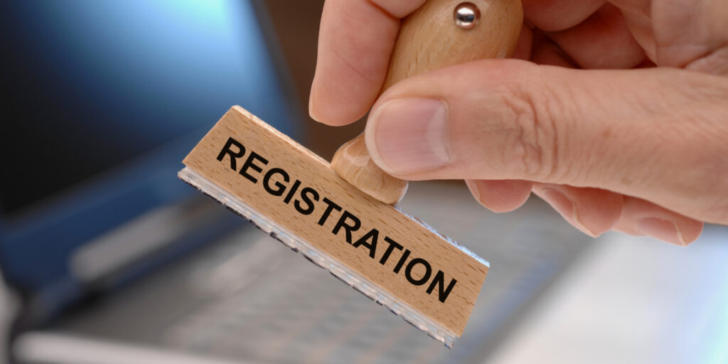 Hand holding wooden registration stamp