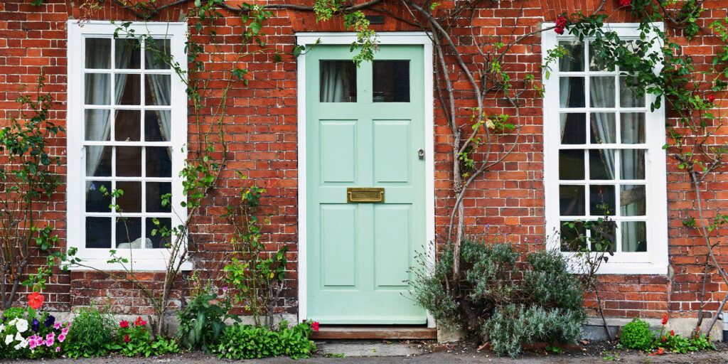 Photo of a house's front door and two windows