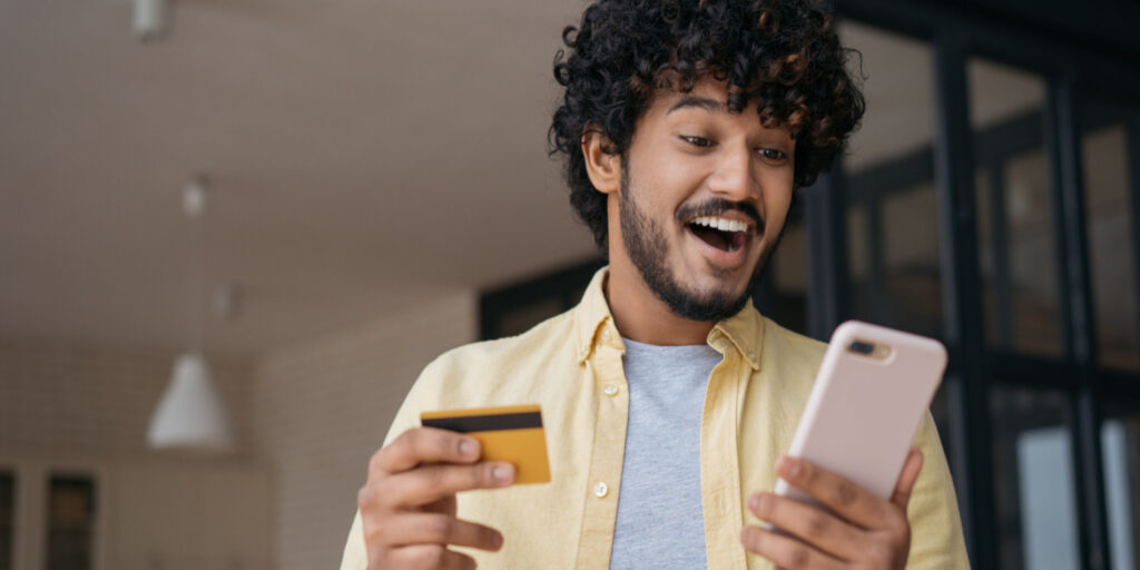 Young businessman delighted with his online business banking app.