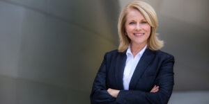 Portrait of female non-execitve director, successful and confidence, smiling with arms crossed.