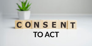 CONSENT - word from wooden blocks with letters, with 'TO ACT' below in black font, illustrating consent to act concept.