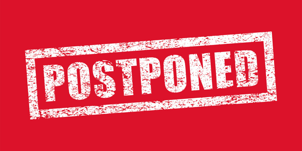 Postponed grunge style rubber stamp. Vector illustration image. Isolated on red background.