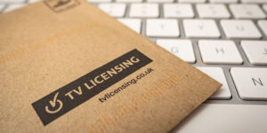 TV Licence envelope lying on a computer keyboard.