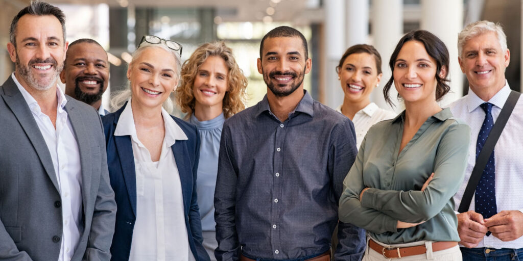 Portrait of a group of partners of an LLP in a modern office looking at camera.