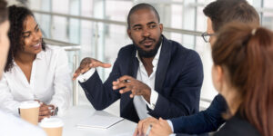 Directors and shareholders having a meeting in a boardroom.