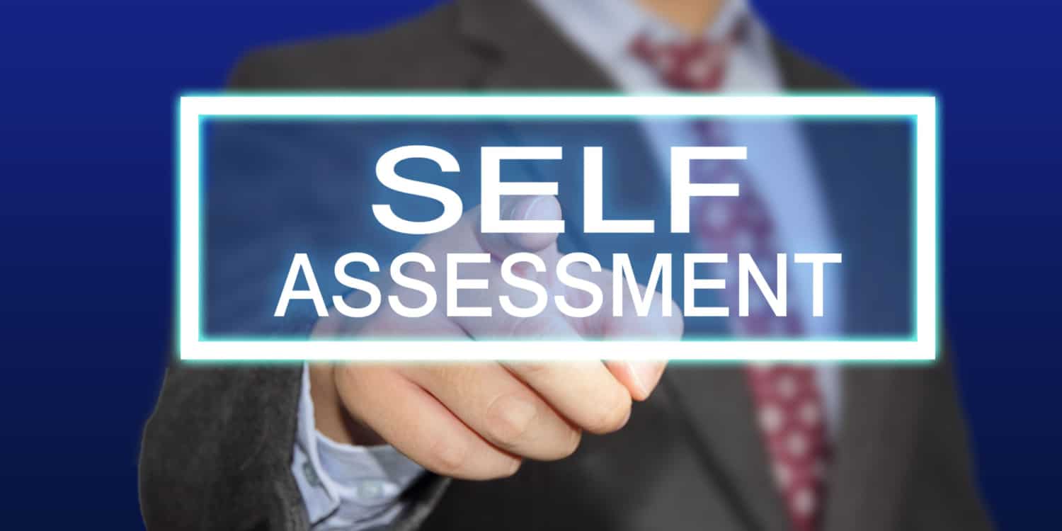 Business concept image of a businessman clicking Self Assessment button on virtual screen over blue background