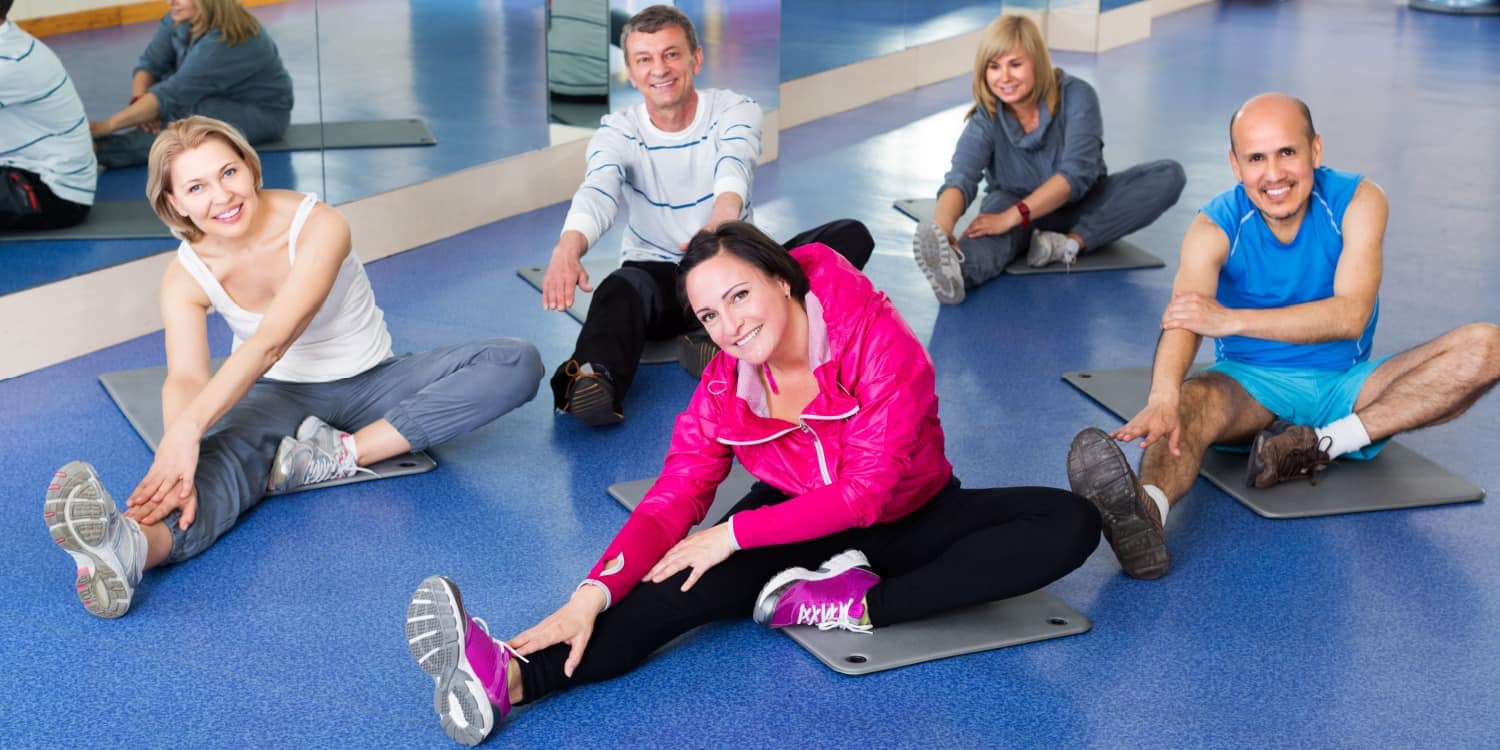 A group of mature active adults doing pilates at their Community Amateur Sports Club (CASC).