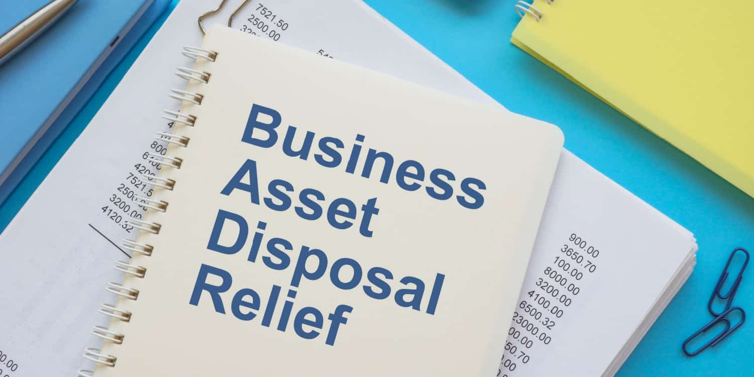 A book titled Business Asset Disposal Relief lying on top of financial papers.