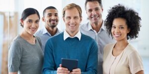 A diverse group of business people with a tablet in an office getting a share code online to prove a right to work in the UK.