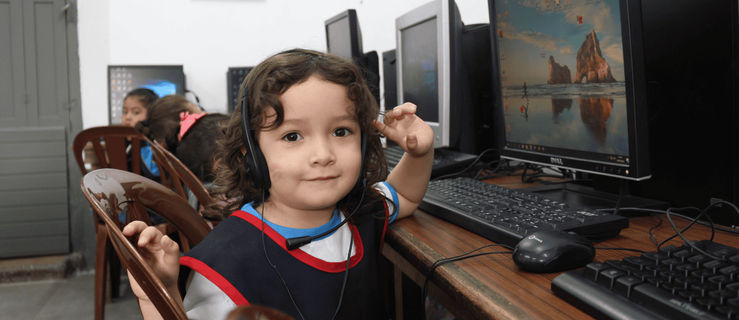 A school girl from the Junkabal School in Guatemala,sitting in front of a computer having a lesson.