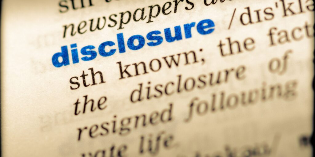 Close-up of the word DISCLOSURE in English dictionary, including the definition and transcription.