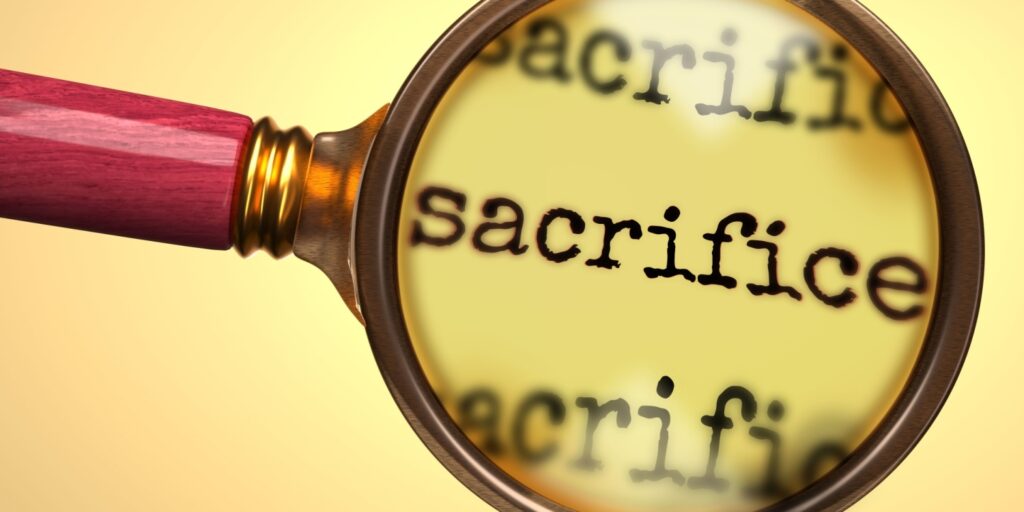 A magnifying glass looking at "sacrifice" on a page, exploring how salary sacrifice can help reduce Employers' National Insurance bills.