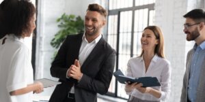 A group of entrepreneurs sharing advice and laughing in an office setting