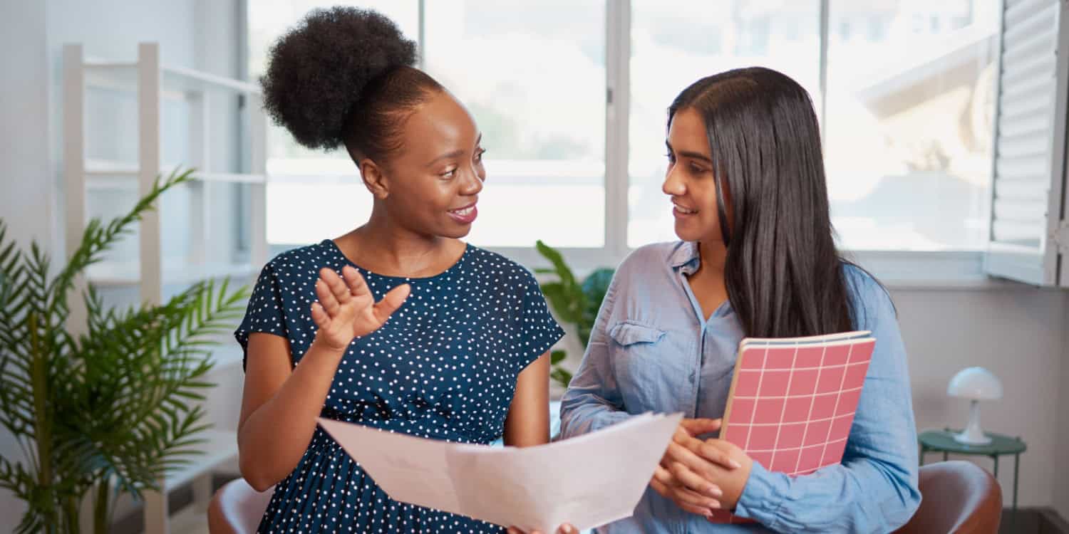 Two women talking in the workplace