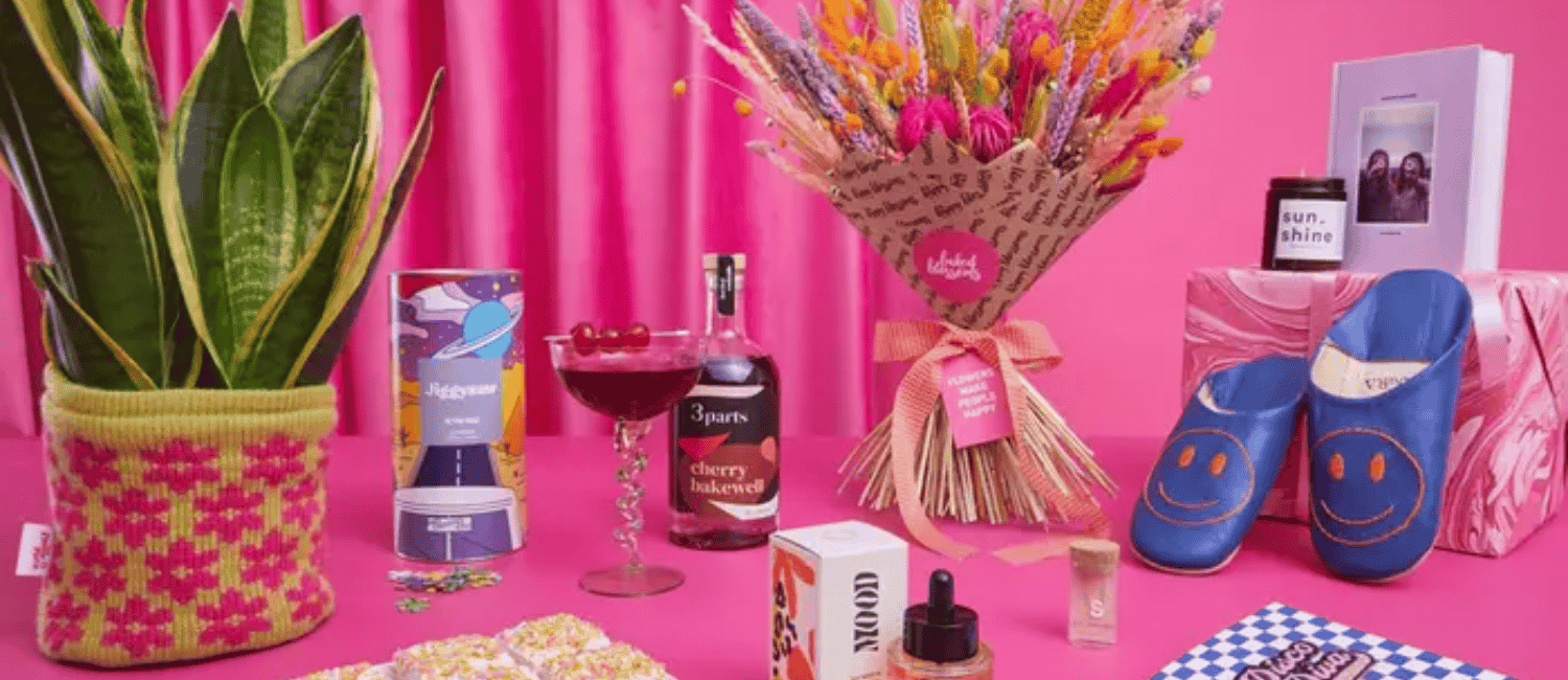 A selection of gifts from Not On The High Street with a pink background.