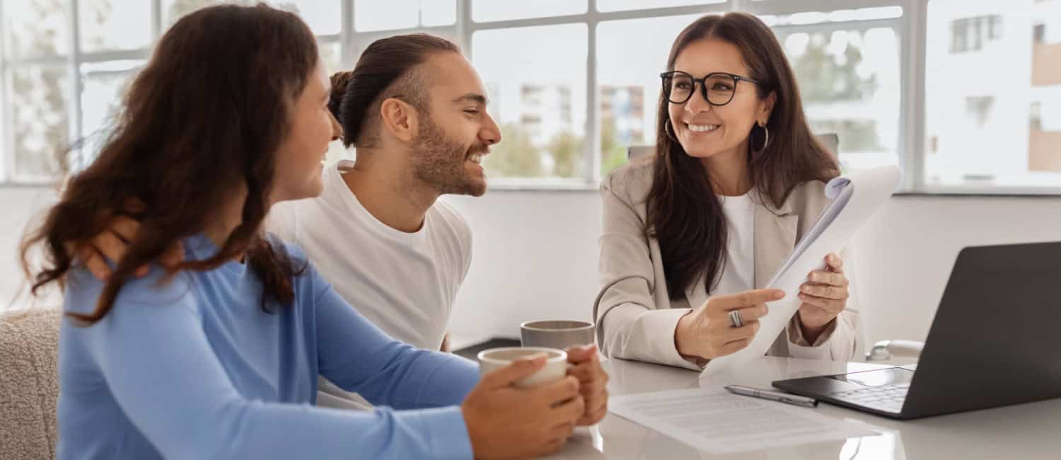 A business startup couple discussing business insurance with their insurance broker.