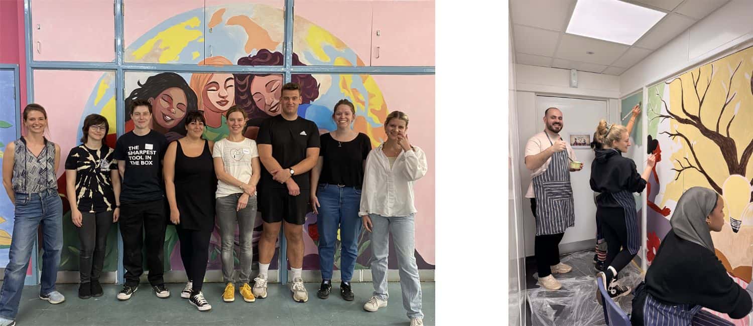 A diverse group of people poses in front of a colourful mural, while others engage in painting a new artwork on the wall.